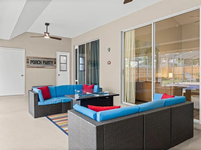 a living room with furniture and a floor to ceiling window