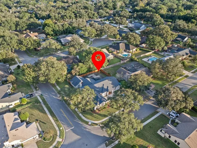 an aerial view of residential house with outdoor space and swimming pool