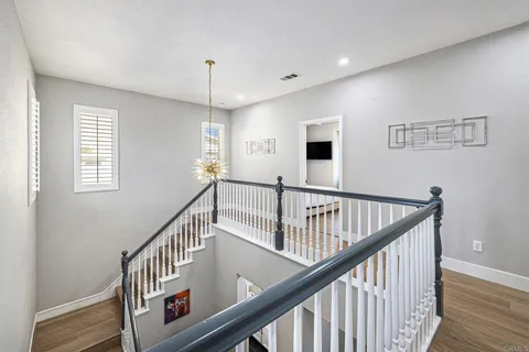 a view of entryway with wooden floor and stairs