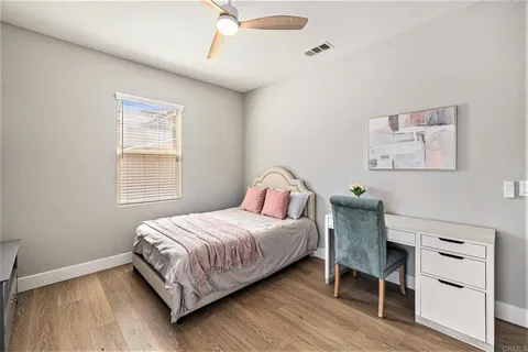 a bedroom with a bed and a desk