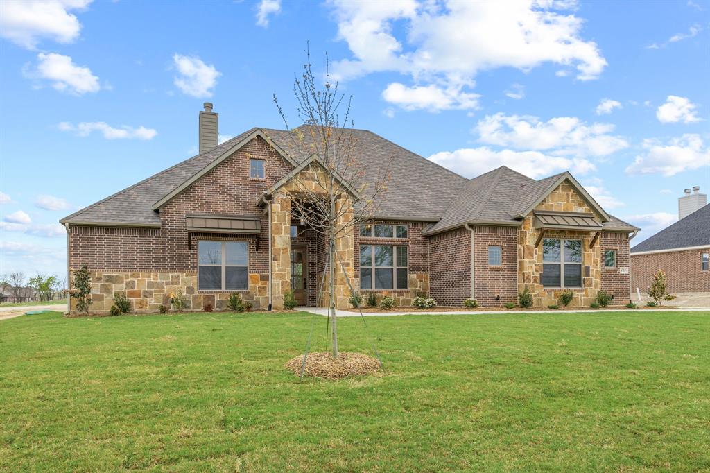6713 Odom Road Sanger, TX 76266 - Photo 1 of 1 Elegant brick and stone exterior with a prominent arched entry