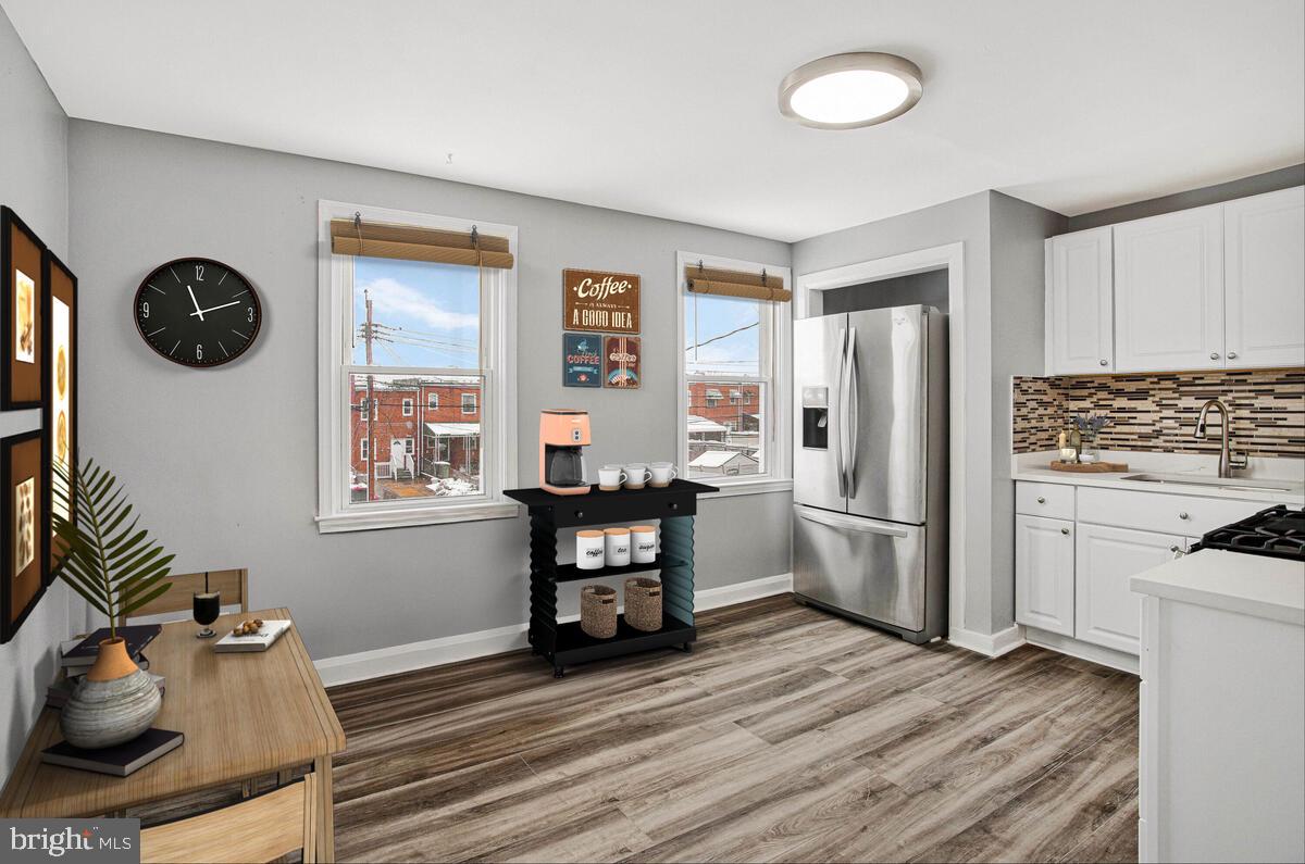 a kitchen with a refrigerator and windows