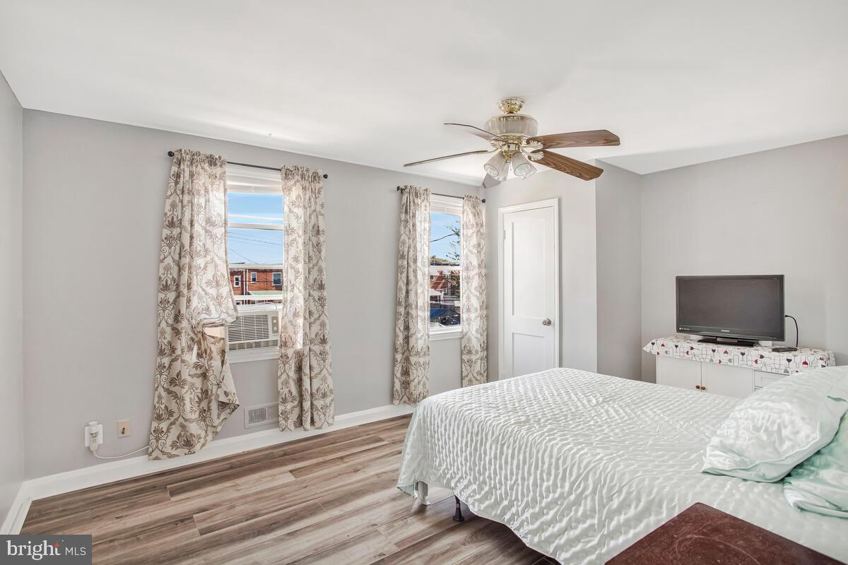 4004 Dudley Avenue Baltimore, MD 21213 - Photo 12 of 36 a bedroom with a bed and a chandelier