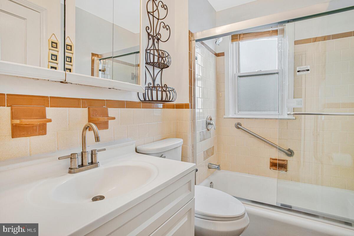 4004 Dudley Avenue Baltimore, MD 21213 - Photo 15 of 36 a bathroom with a sink a toilet and shower
