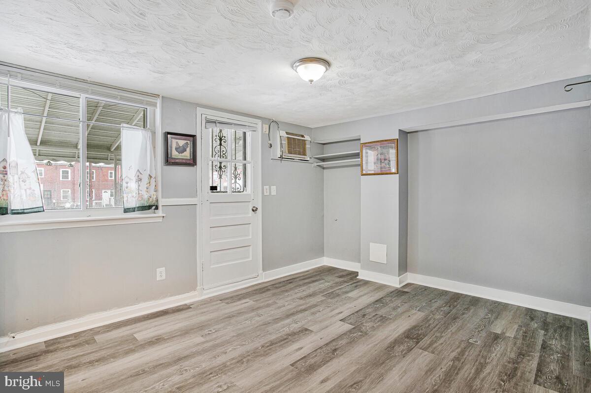 4004 Dudley Avenue Baltimore, MD 21213 - Photo 16 of 36 wooden floor in an empty room with a window