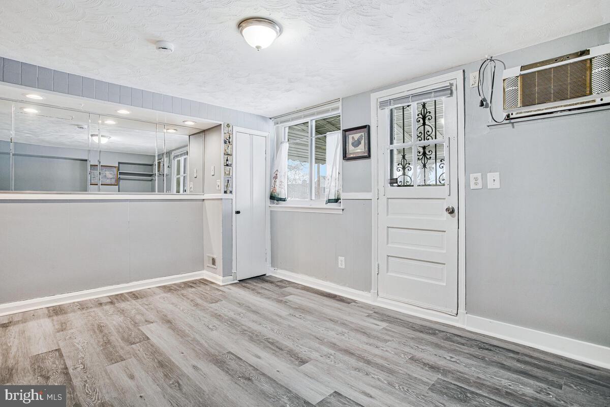 4004 Dudley Avenue Baltimore, MD 21213 - Photo 18 of 36 an empty room with wooden floor and windows