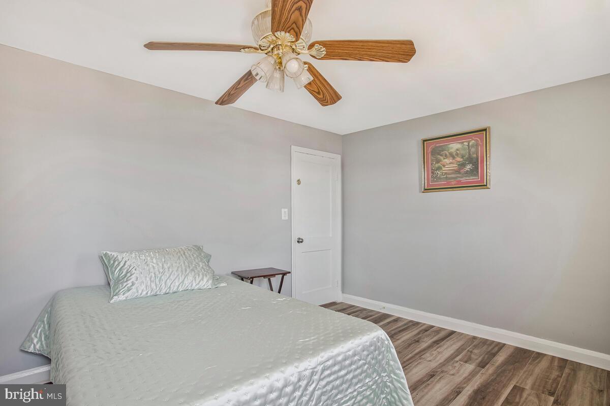 4004 Dudley Avenue Baltimore, MD 21213 - Photo 24 of 36 a bedroom with a bed and a ceiling fan