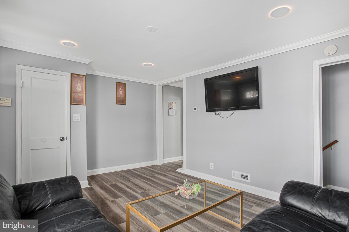4004 Dudley Avenue Baltimore, MD 21213 - Photo 4 of 36 a living room with a flat screen tv and a couch