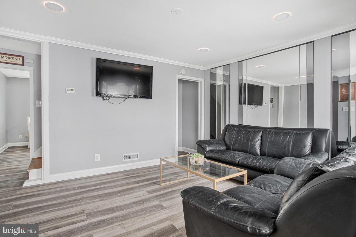 4004 Dudley Avenue Baltimore, MD 21213 - Photo 7 of 36 a living room with furniture and a flat screen tv