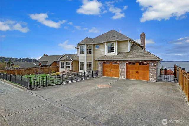a view of a house with a yard and potted plants