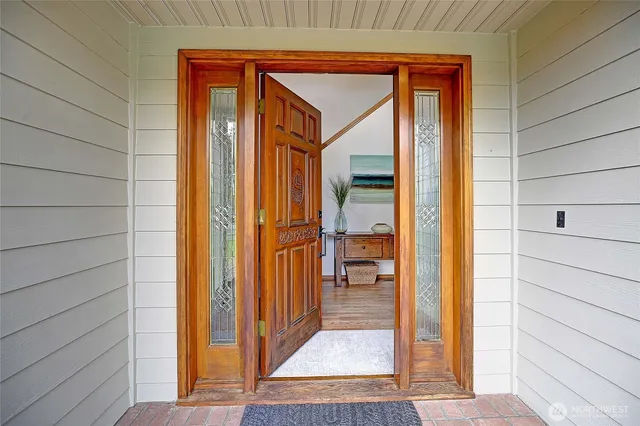a view of an entryway with wooden floor and door