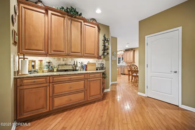 a living room with furniture a fireplace and a large mirror