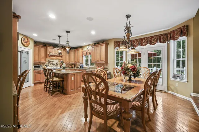 a living room with furniture a flat screen tv and a floor to ceiling window