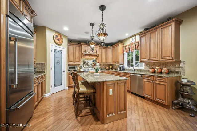 a view of a dining room with furniture wooden floor and chandelier