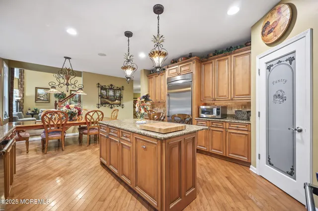 a spacious bedroom with a bed a couch and dresser