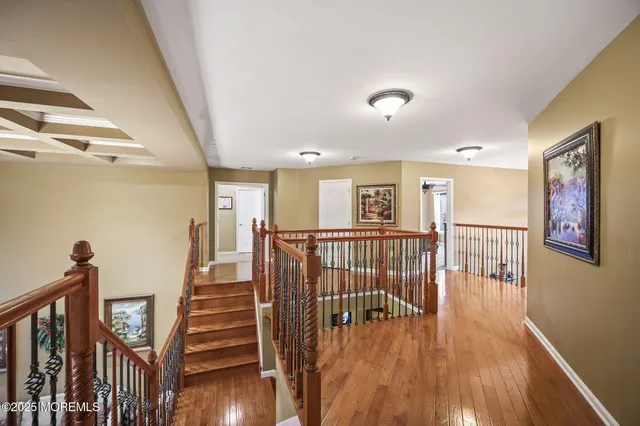 a bathroom with a granite countertop shower a mirror and a toilet