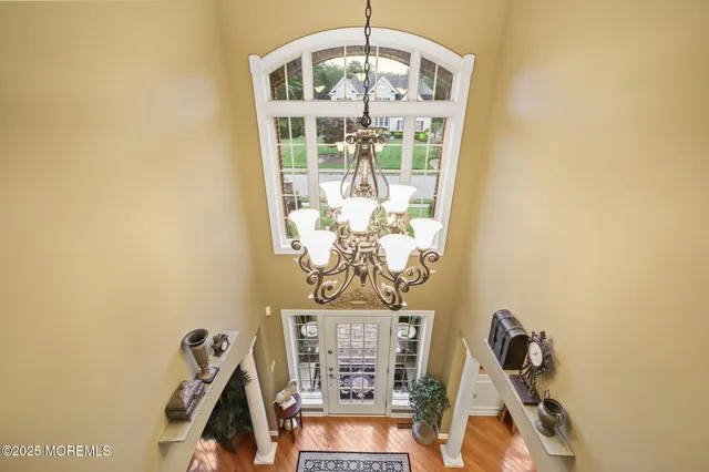 a bed room with a bed and a chandelier