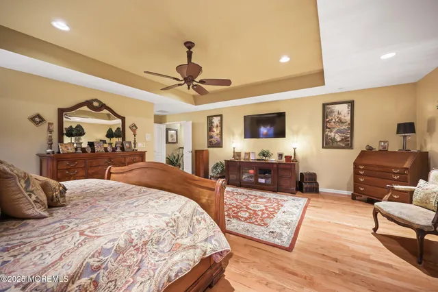 a view of a roof deck with table and chairs under an umbrella with wooden floor and fence