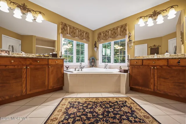 an aerial view of a house with a garden and lake view