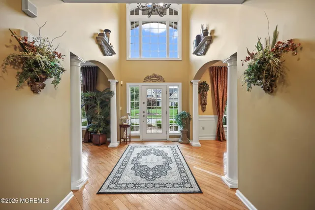 a living room with furniture and a floor to ceiling window