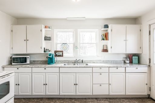 3105 Academy Road Portland, TN 37148 - Photo 7 of 17 a kitchen with granite countertop a sink cabinets and stainless steel appliances