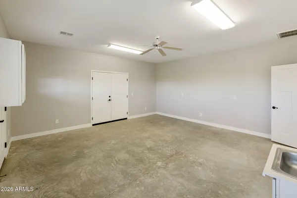 a kitchen with cabinets and wooden floor