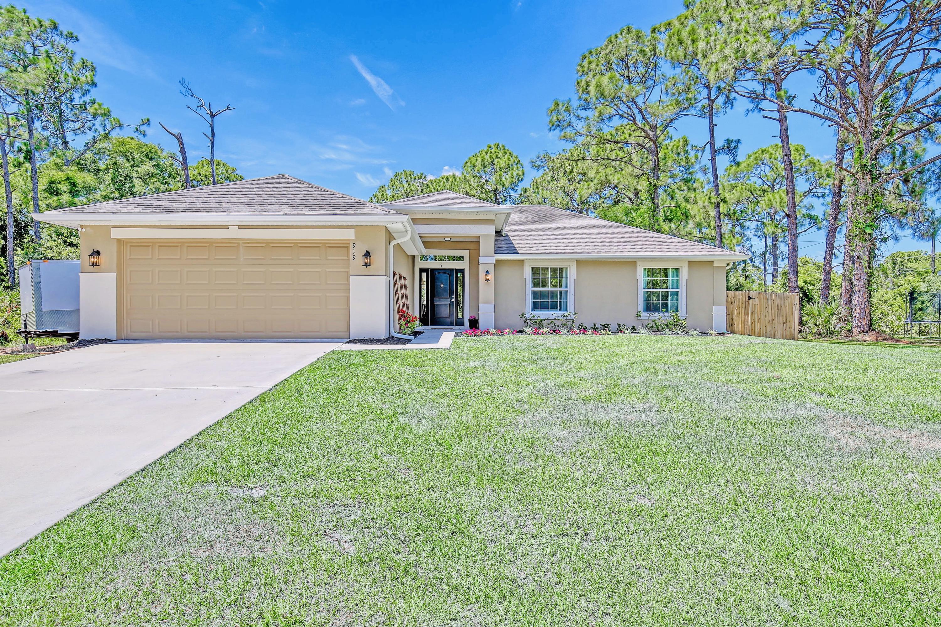 919 Thompson Road Southwest Palm Bay, FL 32908 - Photo 2 of 38 a front view of house with yard and green space