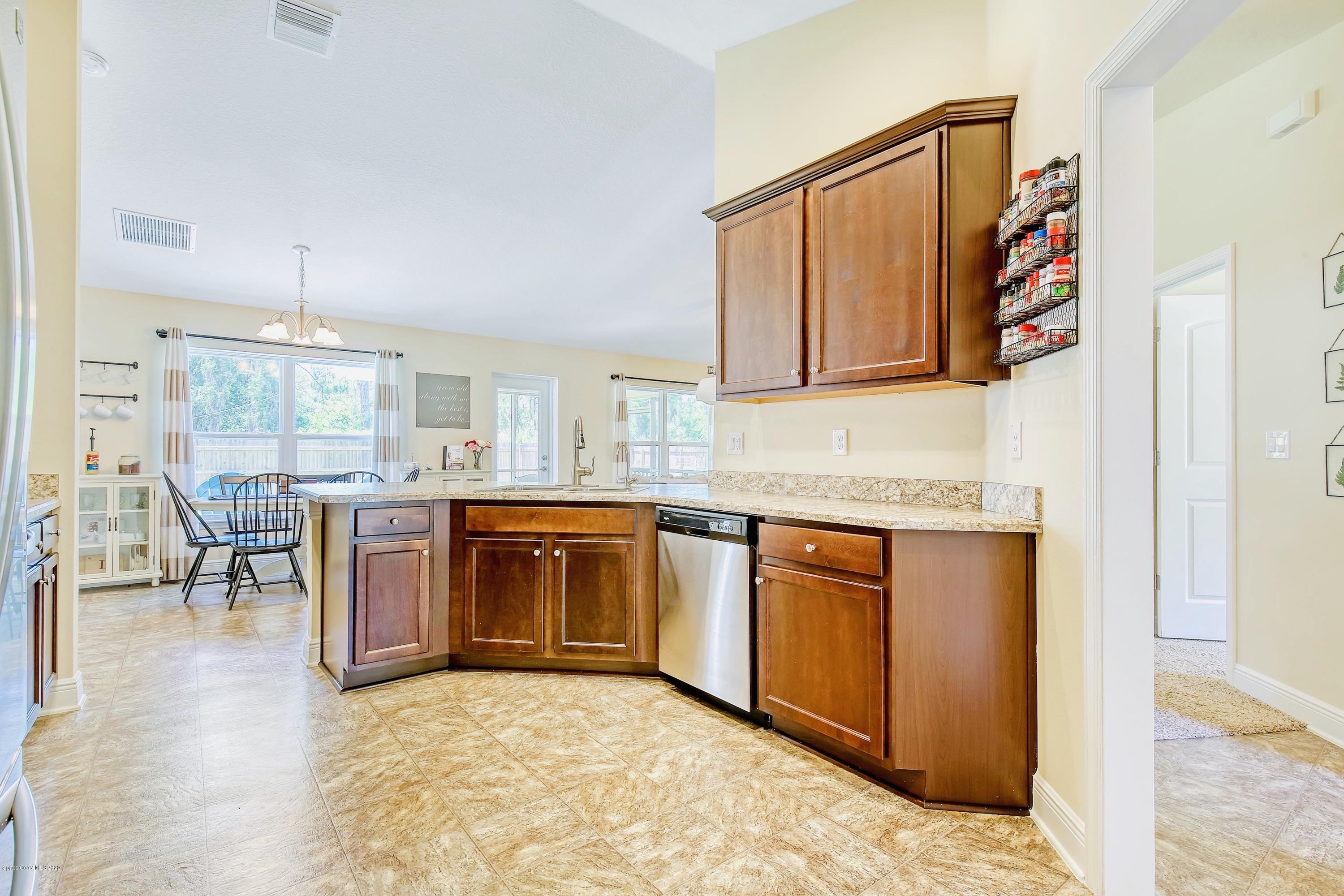 919 Thompson Road Southwest Palm Bay, FL 32908 - Photo 15 of 38 a kitchen with stainless steel appliances granite countertop a stove and cabinets