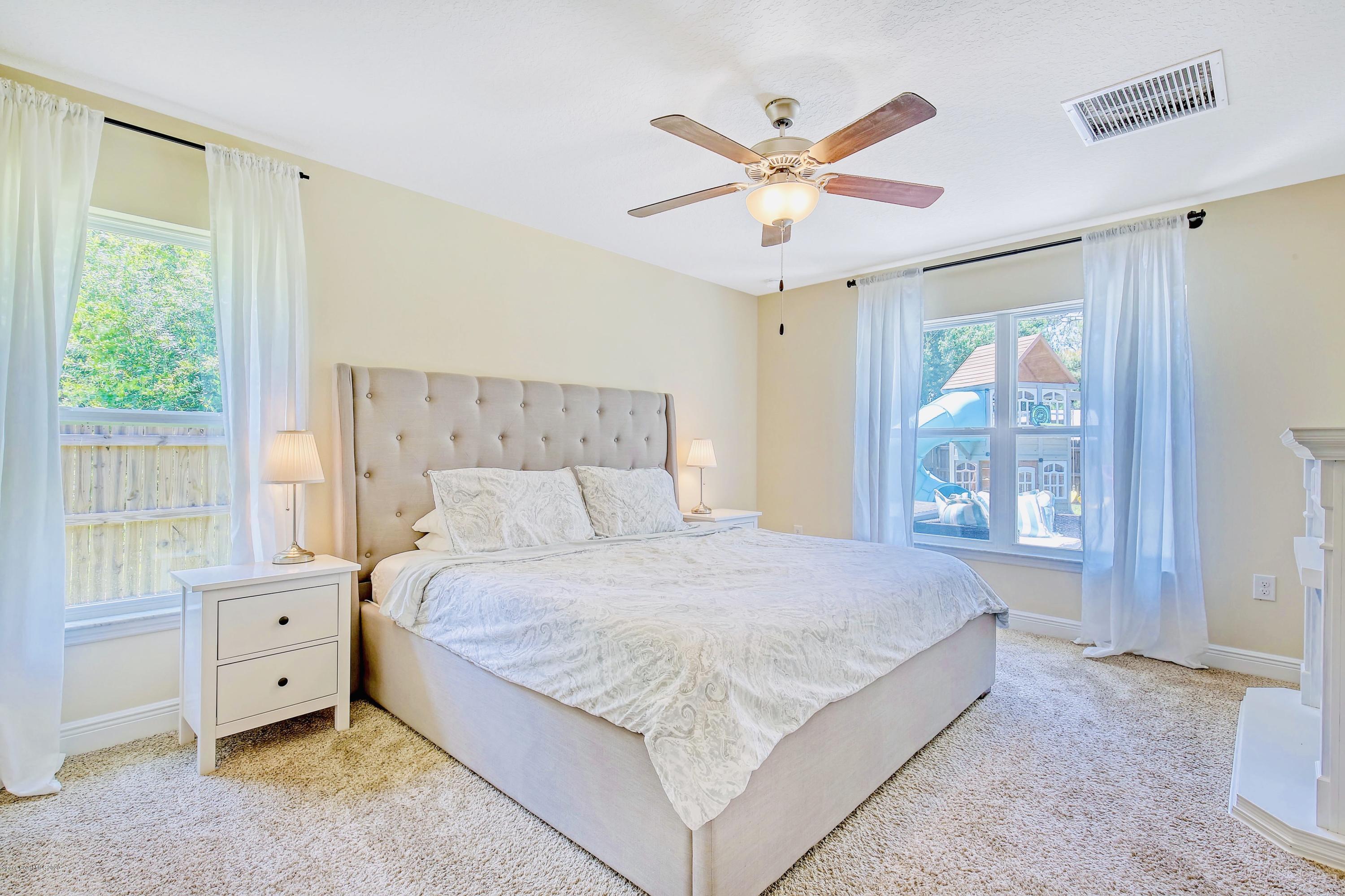 919 Thompson Road Southwest Palm Bay, FL 32908 - Photo 16 of 38 a bedroom with a large bed and a window