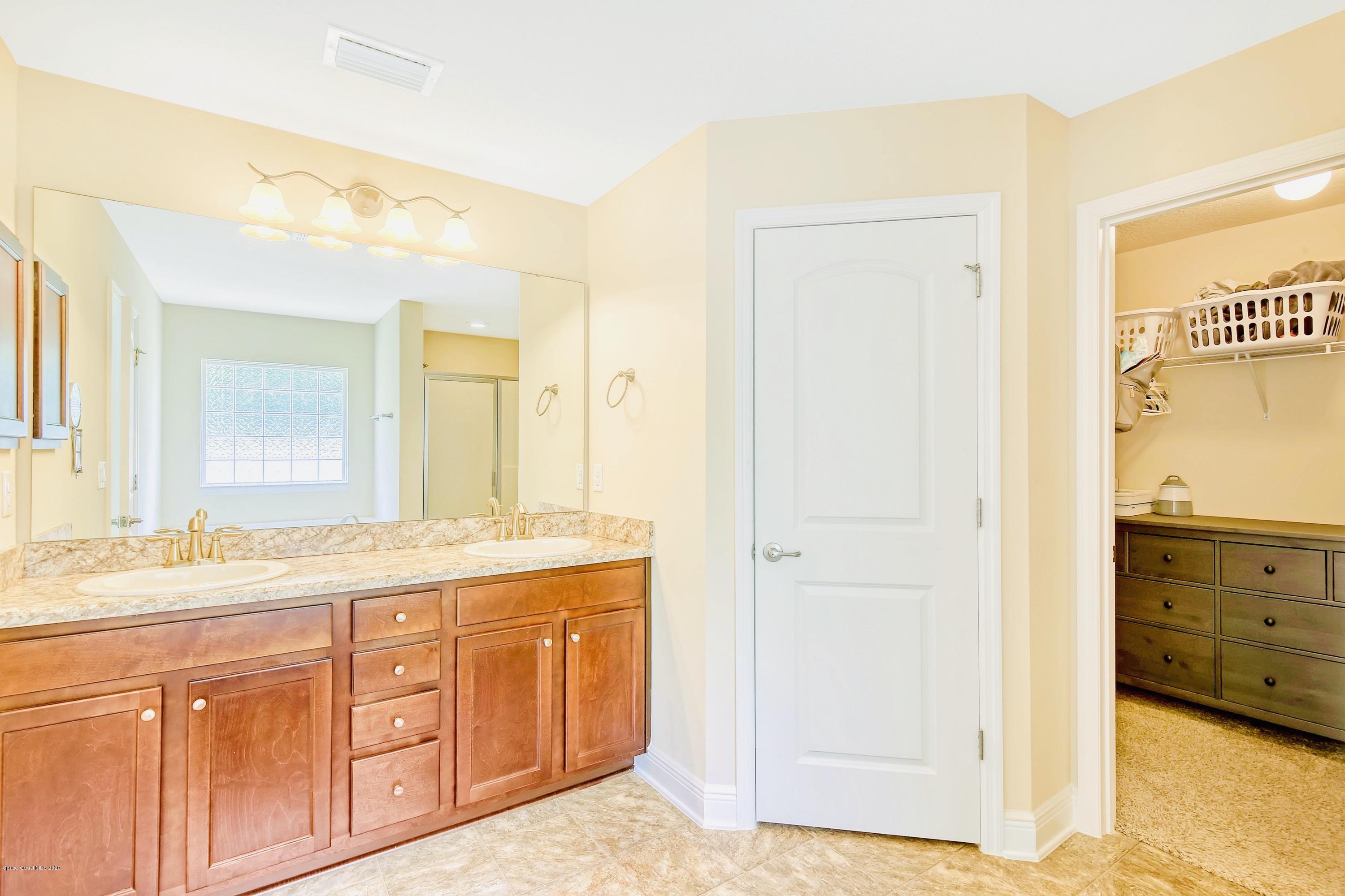 919 Thompson Road Southwest Palm Bay, FL 32908 - Photo 19 of 38 a bathroom with a granite countertop sink mirror and