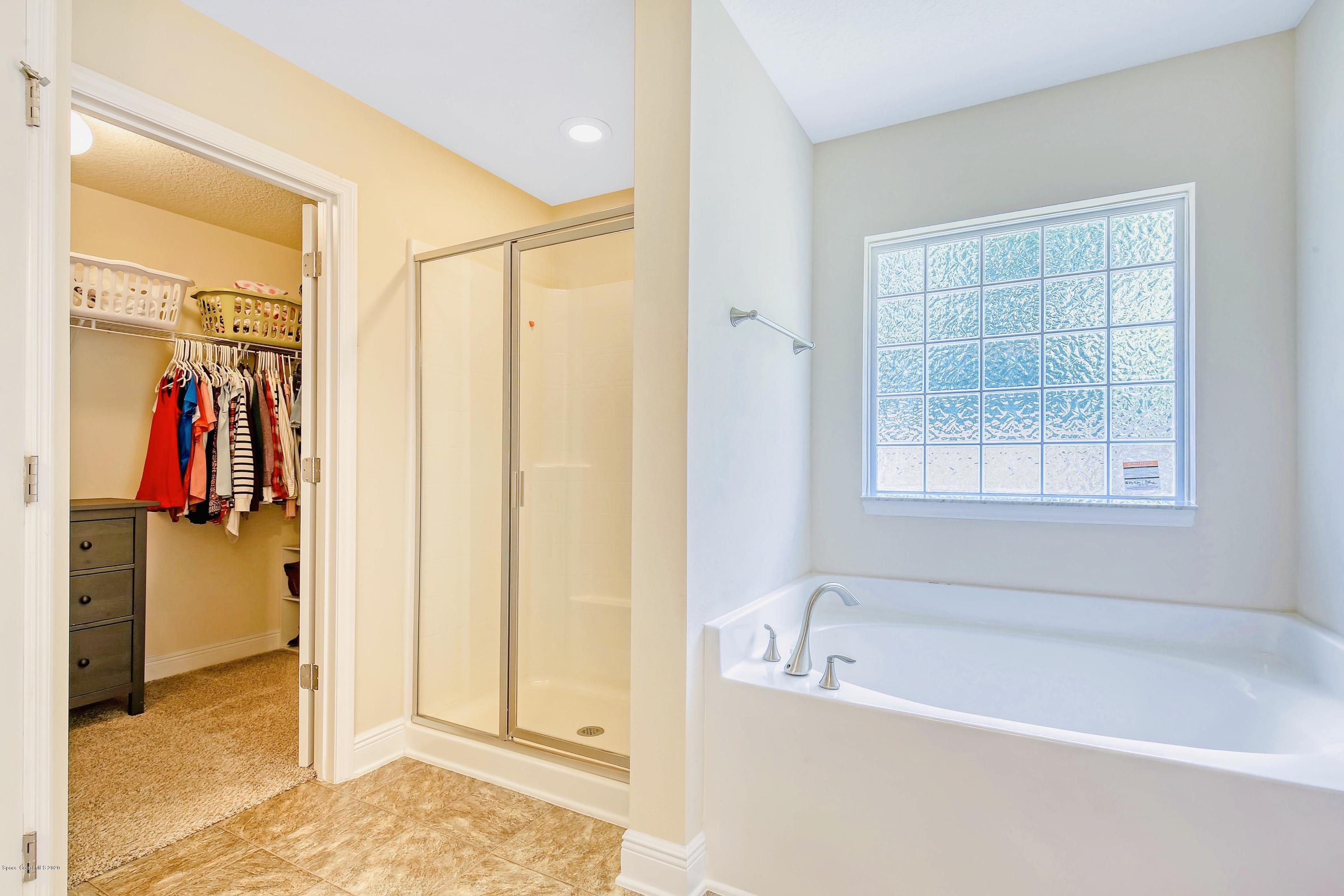 919 Thompson Road Southwest Palm Bay, FL 32908 - Photo 20 of 38 a bathroom with a tub and a shower