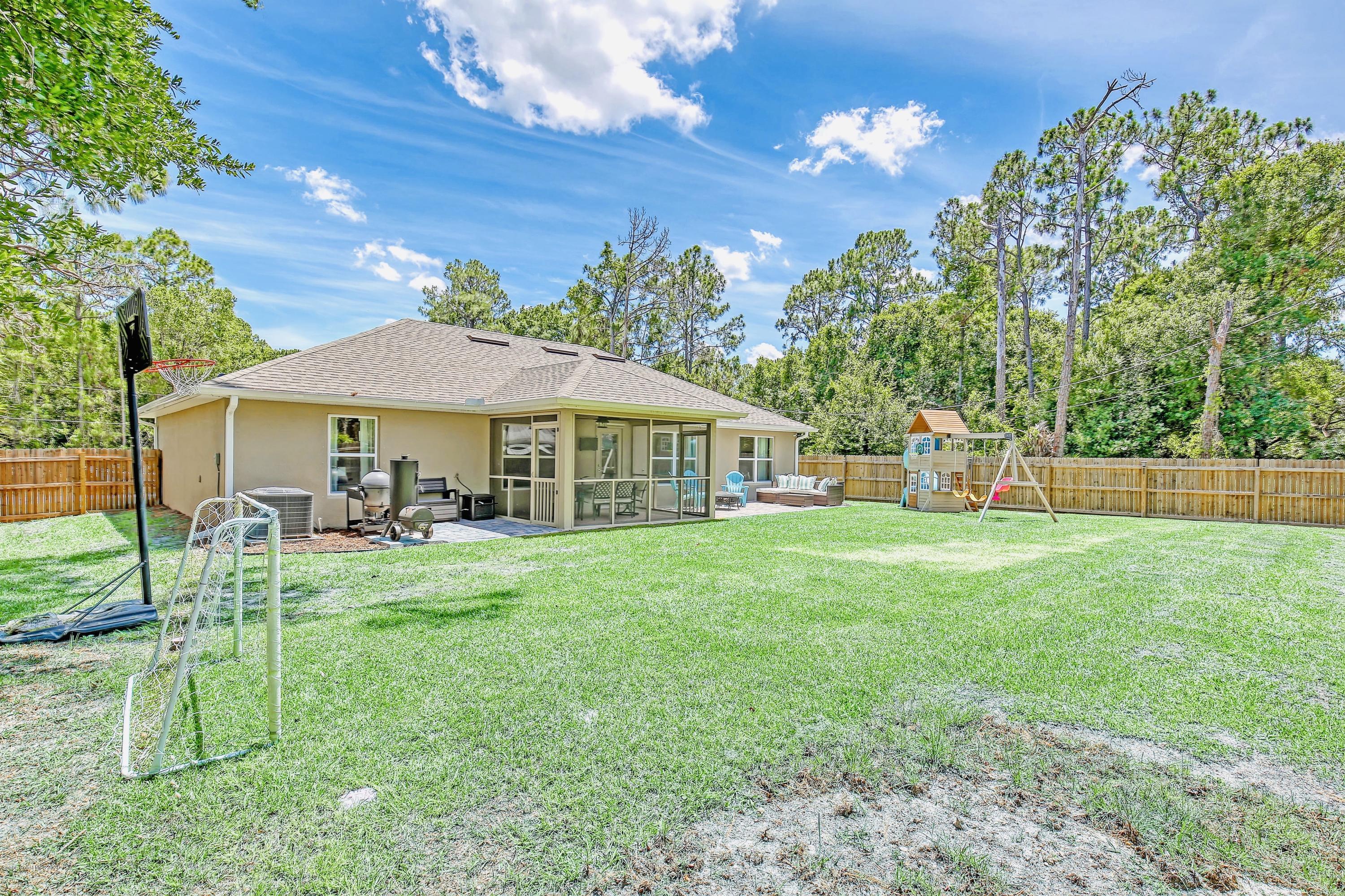919 Thompson Road Southwest Palm Bay, FL 32908 - Photo 29 of 38 a front view of a house with yard porch and furniture