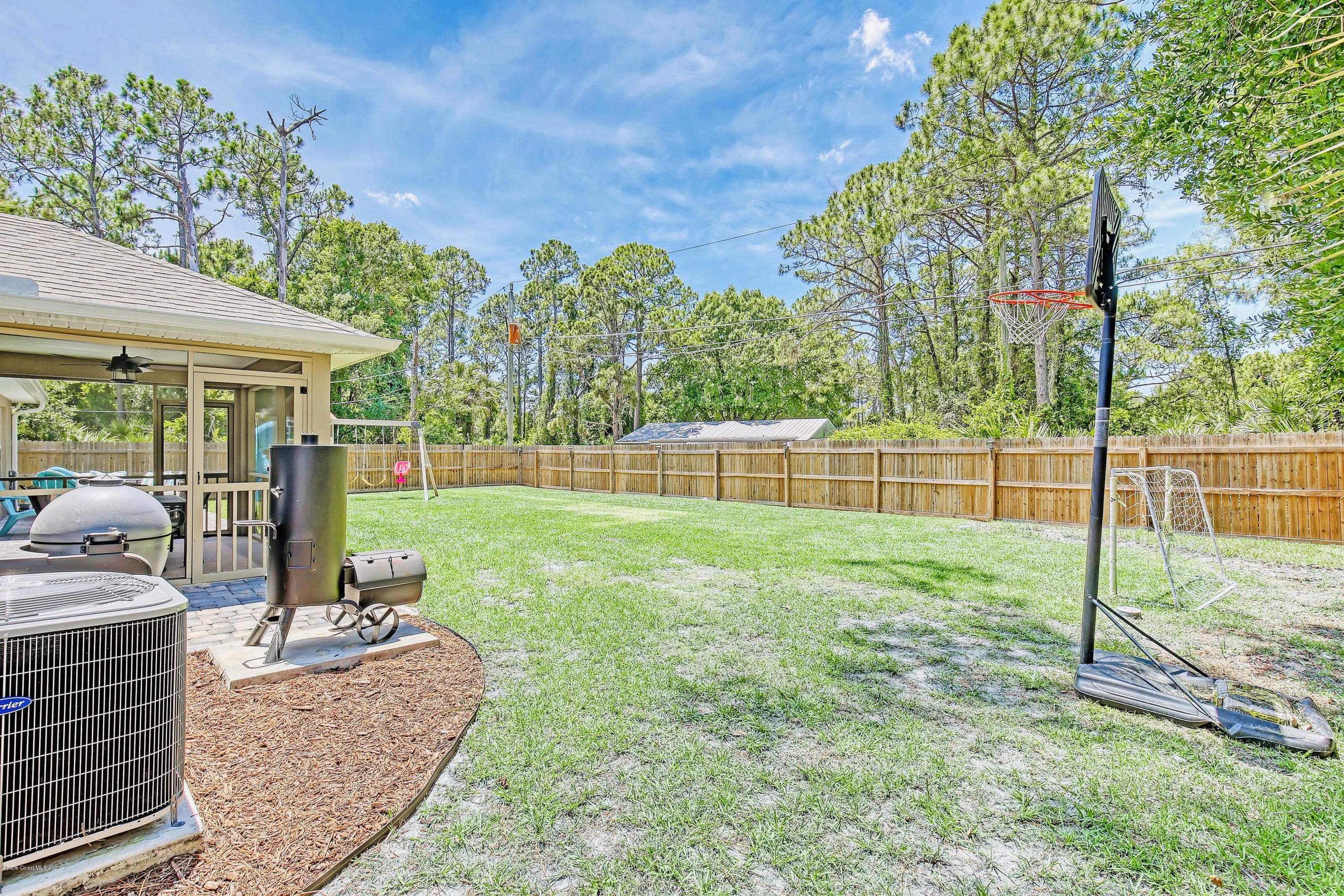 919 Thompson Road Southwest Palm Bay, FL 32908 - Photo 30 of 38 a view of a backyard with sitting area