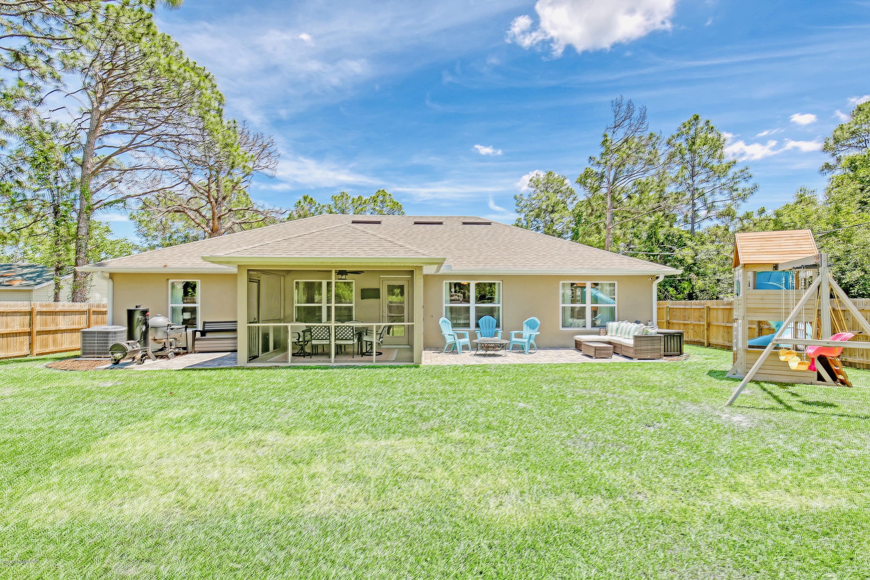 919 Thompson Road Southwest Palm Bay, FL 32908 - Photo 31 of 38 a view of a house with garden and sitting area