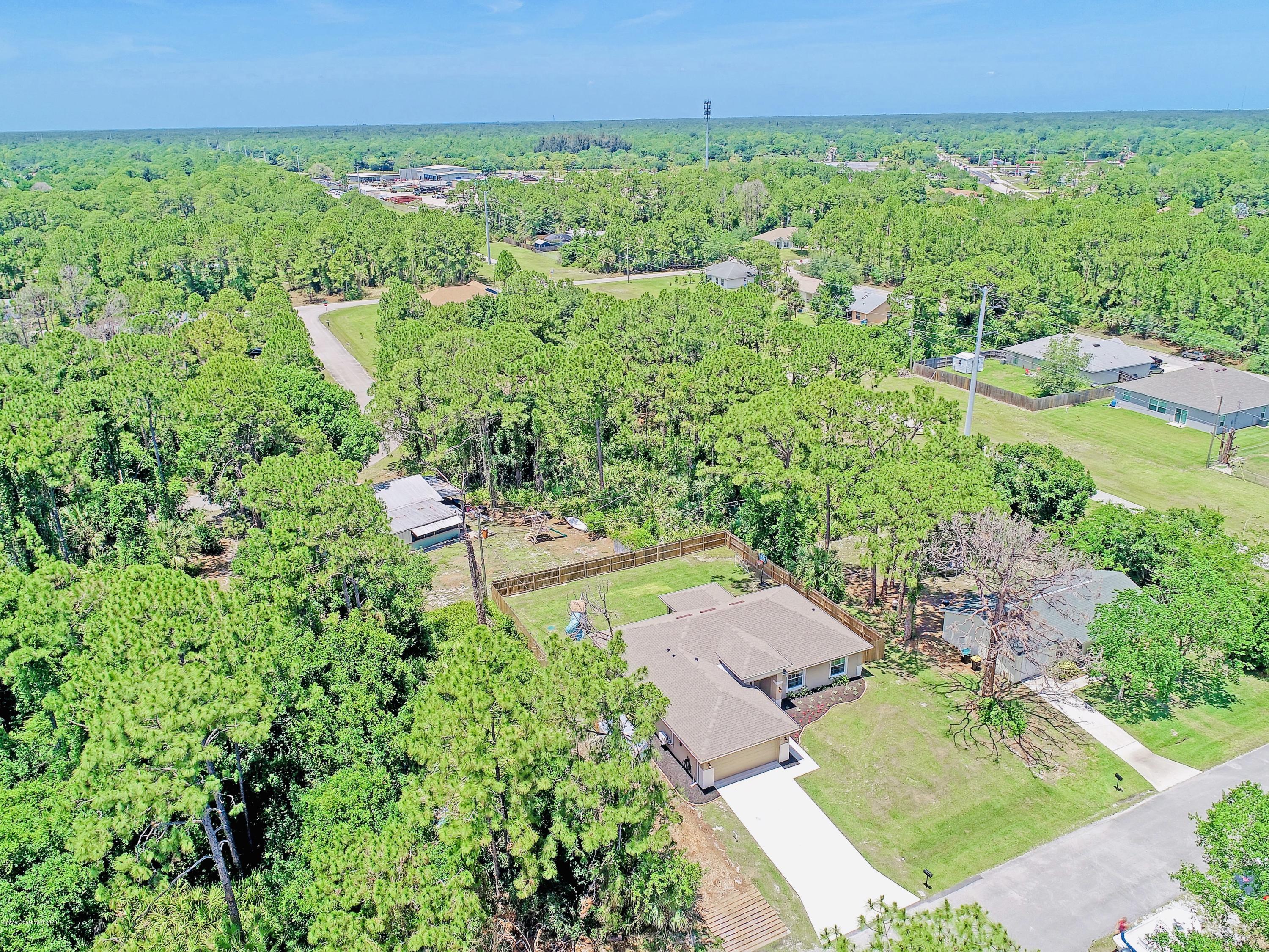919 Thompson Road Southwest Palm Bay, FL 32908 - Photo 35 of 38 an aerial view of a residential houses with outdoor space and street view