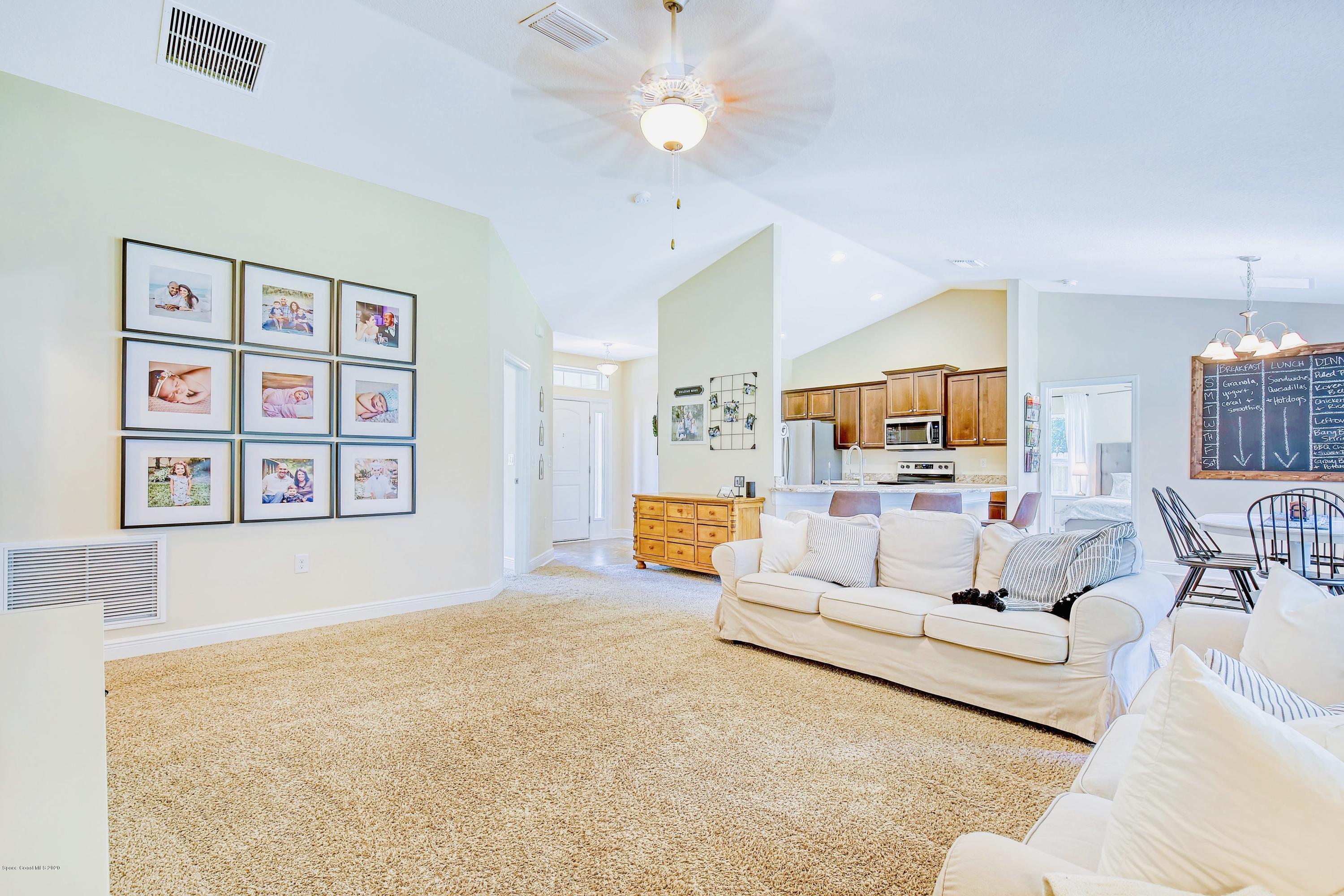 919 Thompson Road Southwest Palm Bay, FL 32908 - Photo 9 of 38 a living room with furniture and wooden floor
