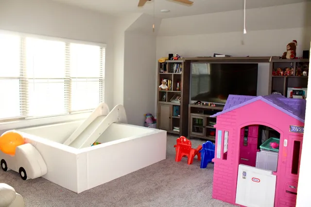 a living room with furniture and a floor to ceiling window