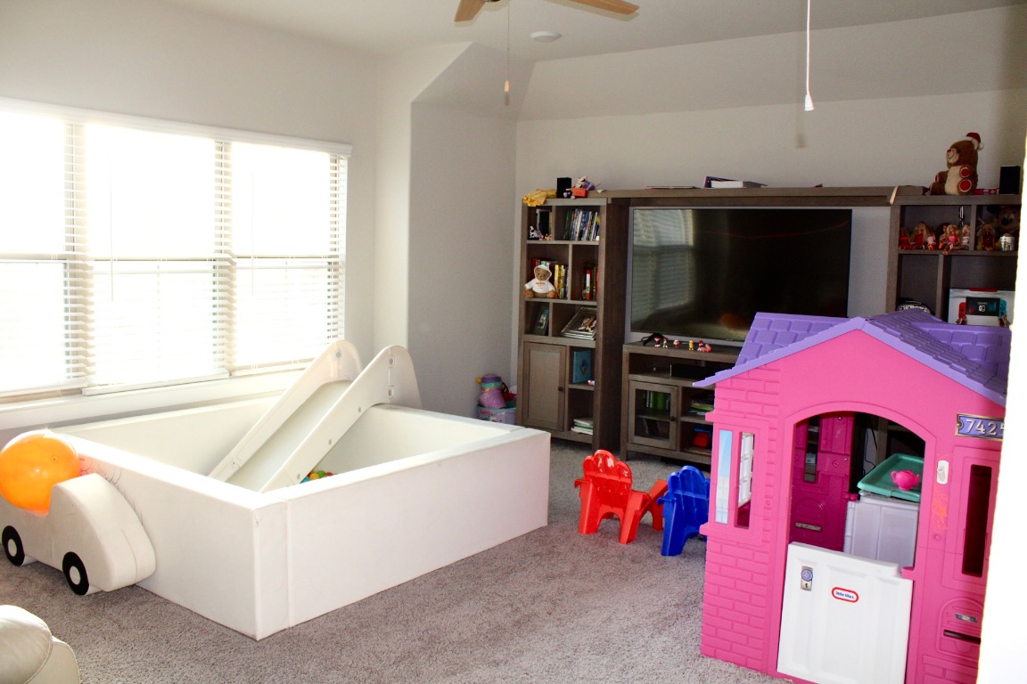 174 Gullivers Drive Elgin, TX 78621 - Photo 12 of 28 a living room with furniture and a floor to ceiling window