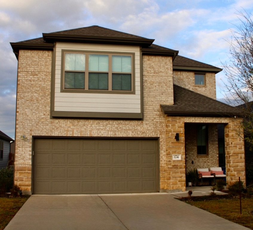 174 Gullivers Drive Elgin, TX 78621 - Photo 2 of 28 a front view of a house with a garage