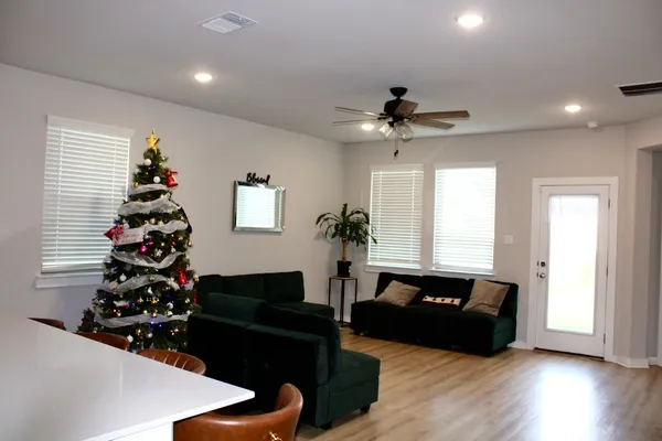 a living room with furniture flowers and a window
