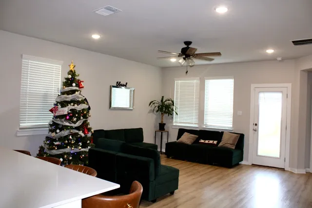 a living room with furniture flowers and a window