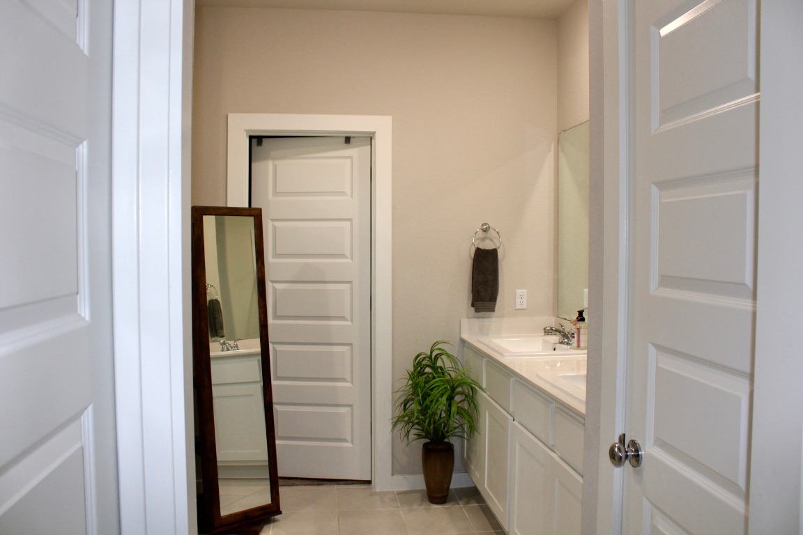 174 Gullivers Drive Elgin, TX 78621 - Photo 9 of 28 a bathroom with a shower and a sink
