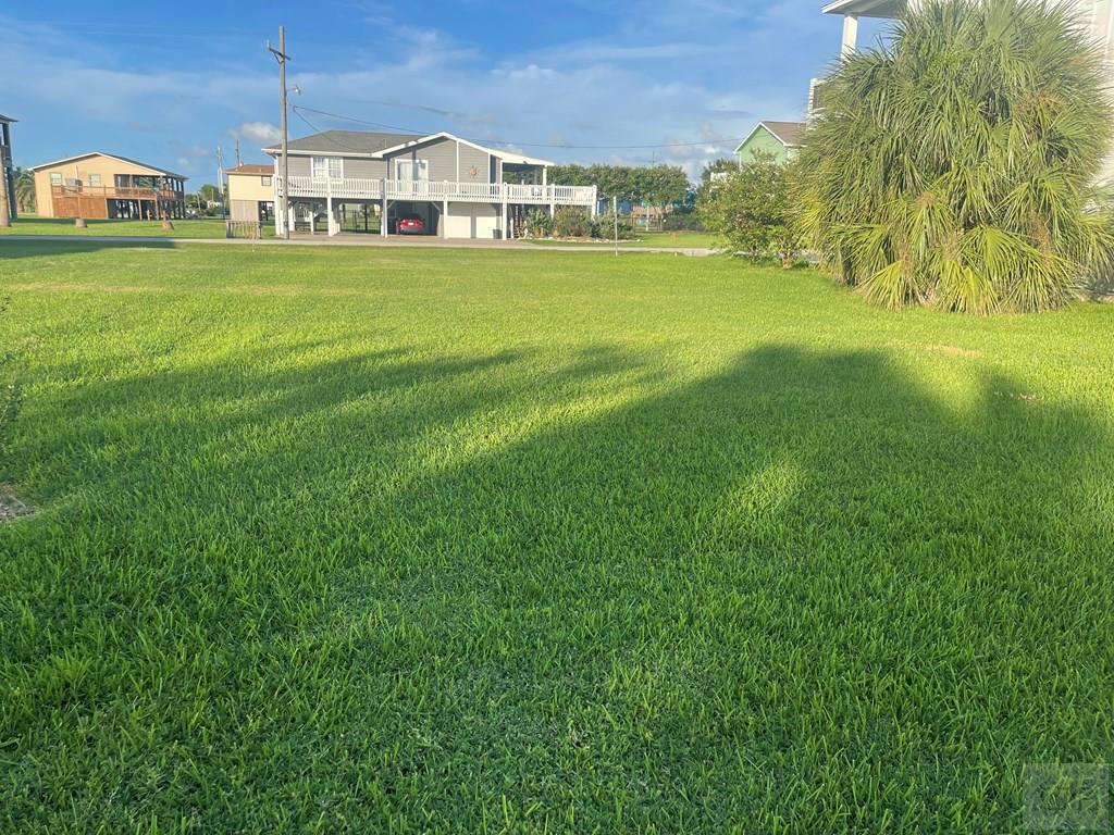 971 Surfview Crystal Beach, TX 77650 - Photo 2 of 4 a yellow and white house with a big yard
