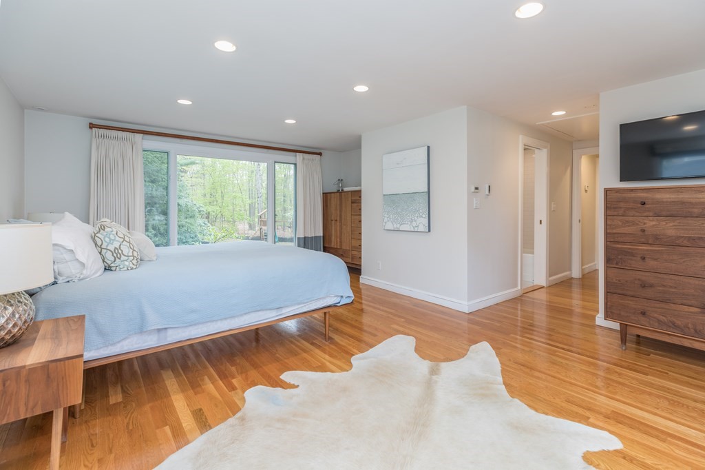 88 Lindbergh Avenue Needham, MA 02494 - Photo 11 of 26 a spacious bedroom with a bed and wooden floor