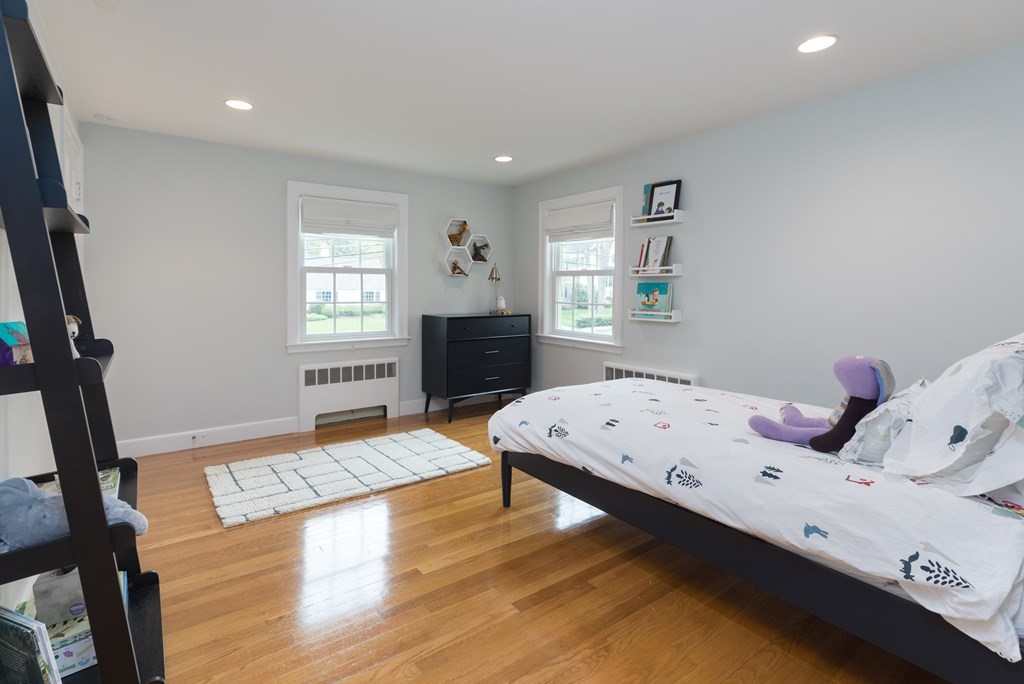 88 Lindbergh Avenue Needham, MA 02494 - Photo 15 of 26 a bedroom with a bed and wooden floor