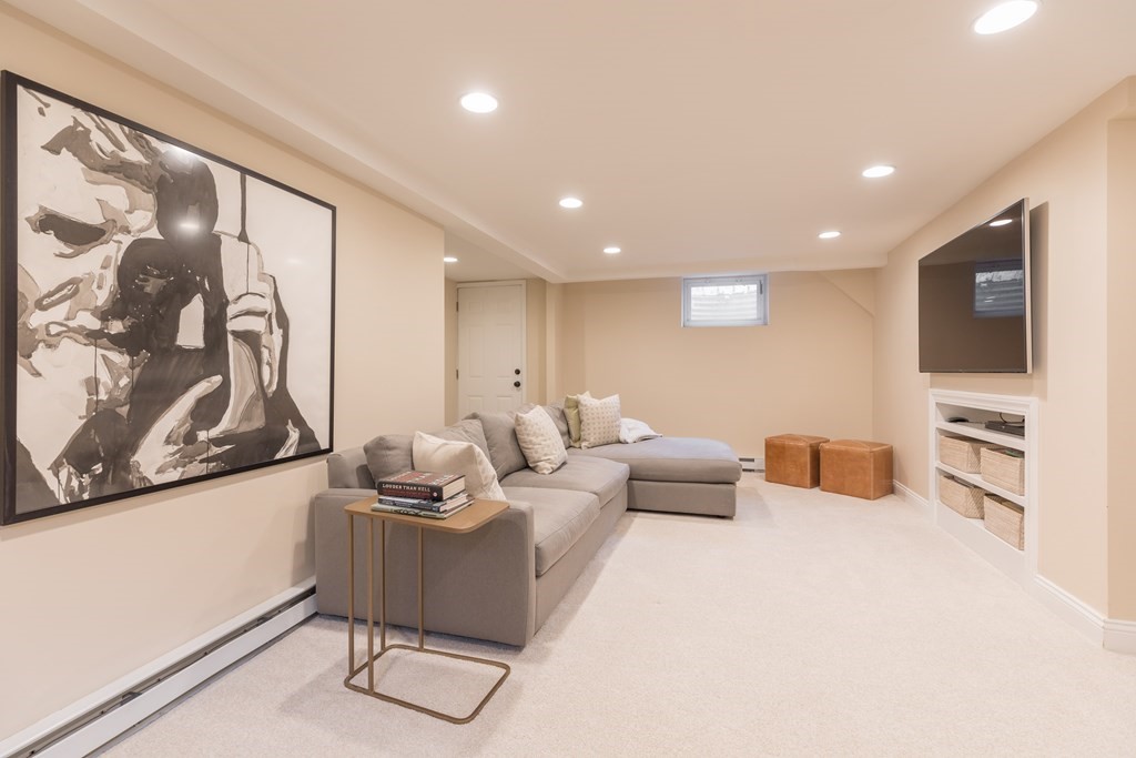88 Lindbergh Avenue Needham, MA 02494 - Photo 18 of 26 a living room with furniture and a flat screen tv