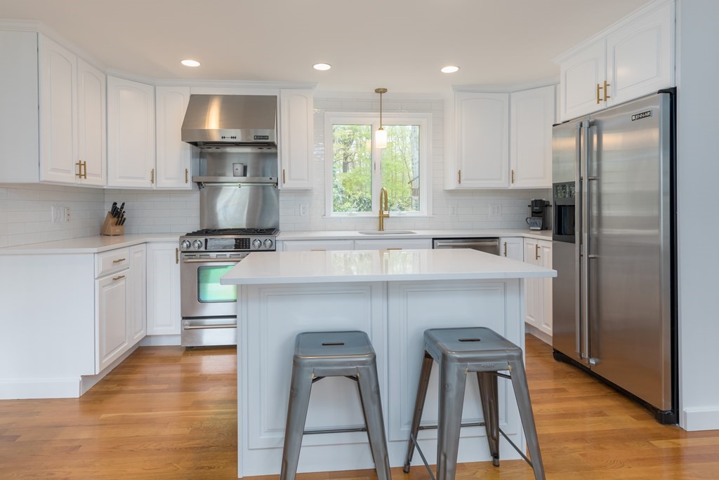 88 Lindbergh Avenue Needham, MA 02494 - Photo 2 of 26 a kitchen with stainless steel appliances a refrigerator sink and wooden cabinets