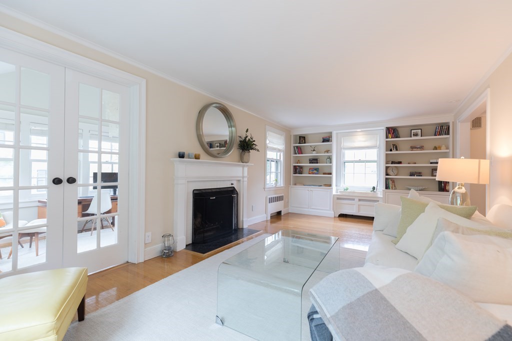 88 Lindbergh Avenue Needham, MA 02494 - Photo 6 of 26 a spacious bedroom with a large bed and a fireplace