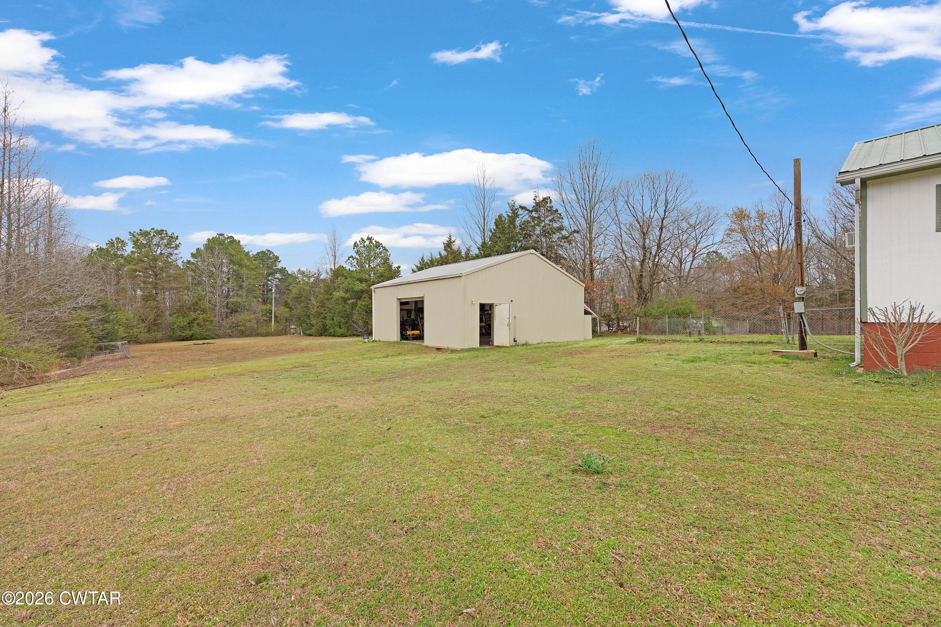 65 Aldridge Lane Jackson, TN 38305 - Photo 11 of 14 a view of a house with backyard and tree