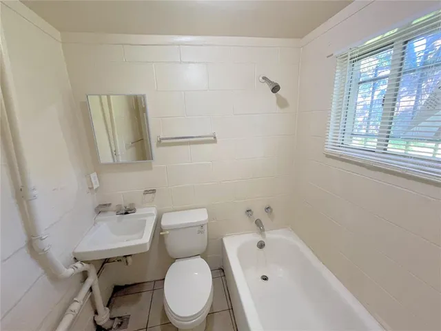 a bathroom with a bathtub and window